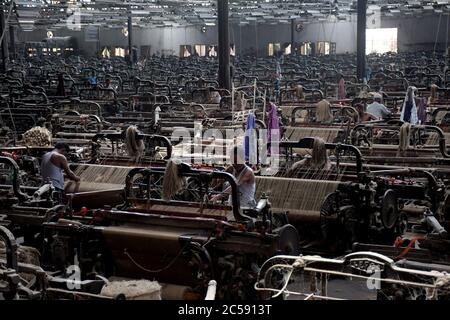 DHAKA, BANGLADESH - 01JULY 2020:  Workers busy in making jute sacks at jute processing mill in Narayanganj near Dhaka,. Jute Industry in Bangladesh is an industry that is historically and culturally important that once was the biggest industry in the region. Stock Photo