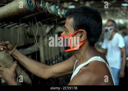 DHAKA, BANGLADESH - 01JULY 2020:  Workers busy in making jute sacks at jute processing mill in Narayanganj near Dhaka,. Jute Industry in Bangladesh is an industry that is historically and culturally important that once was the biggest industry in the region. Stock Photo