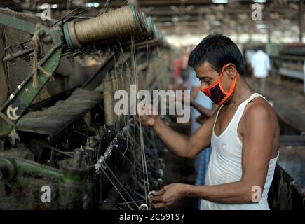 DHAKA, BANGLADESH - 01JULY 2020:  Workers busy in making jute sacks at jute processing mill in Narayanganj near Dhaka,. Jute Industry in Bangladesh is an industry that is historically and culturally important that once was the biggest industry in the region. Stock Photo