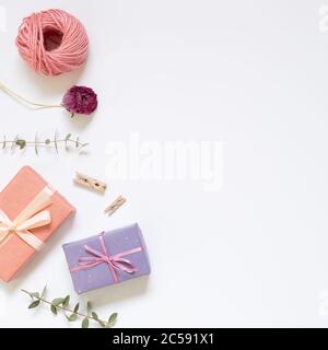 Gift boxes with wrapping tools on white background. top view, copy space Stock Photo