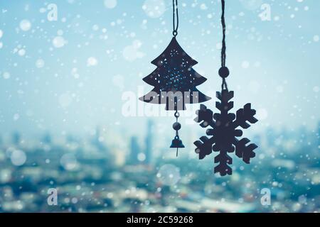 christmas ornament ( Snowflake ) hanging mobile on window with blur outdoor landscape background.season and holiday concepts Stock Photo