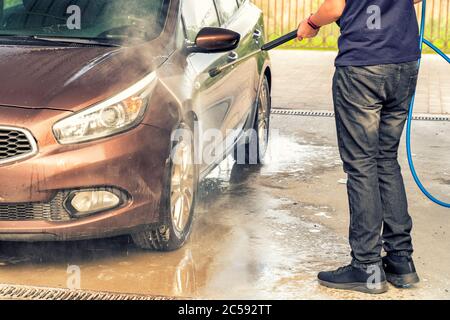 Man washes car with gun for automo. self-service car wash Stock Photo