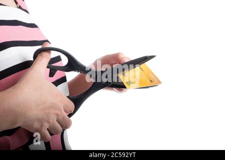 Close up young woman hand cutting up a credit card with scissors to stop spending on shopping at the white background Stock Photo