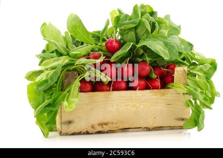 fresh radishes in a wooden crate on a white background Stock Photo