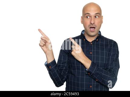 Shocked bald man looking aside and pointing fingers to copy space. Isolated Stock Photo