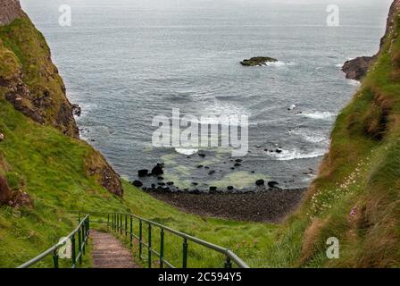 The Dunluce Castle sorrounded by sea, rocks and cloudy days with rain on its way. Stock Photo