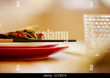 Shot of plates on dining table with napkin and chopsticks Stock Photo