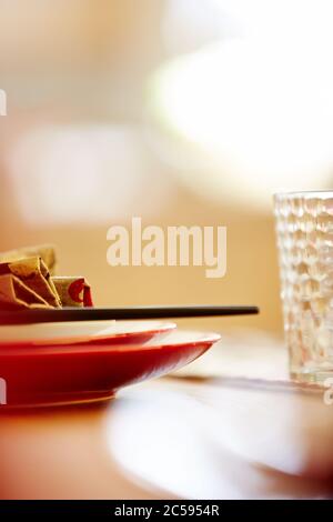 Shot of plates on dining table with napkin and chopsticks Stock Photo