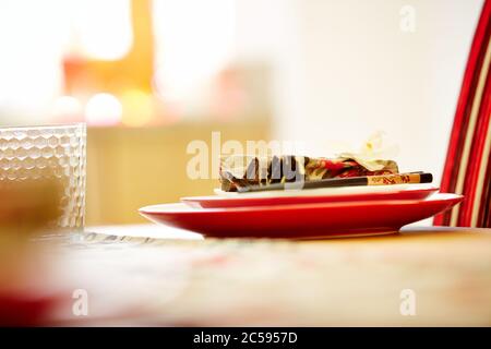 Shot of plates on dining table with napkin and chopsticks Stock Photo