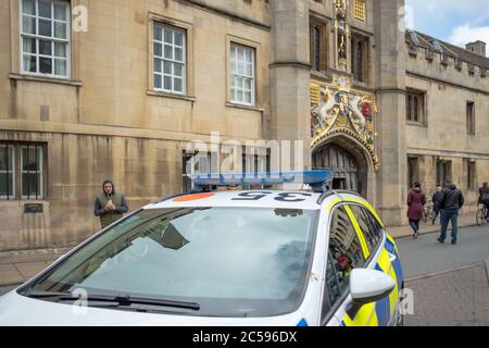 Detailed view of a British Police Vehicle seen parked near a busy street, responding to an emergency call. Detail of the hood and decals are evident. Stock Photo