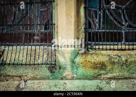 Close-up view of rusting copper metal seen within leaded windows of an english church. Copper sulphate is seen running from the stonework. Stock Photo