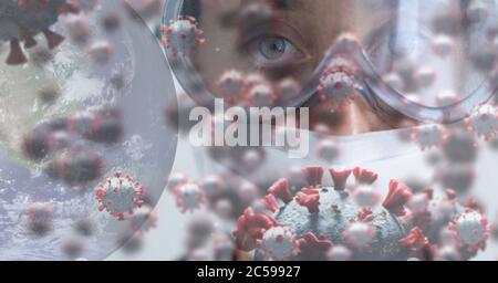 Covid-19 cells and globe against scientist wearing face mask Stock Photo