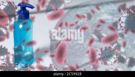 Covid-19 cells and globe against bottle of sanitizer in background Stock Photo