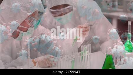 Covid-19 cells against two scientists working in laboratory Stock Photo