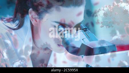 Covid-19 cells against female scientist using a microscope Stock Photo
