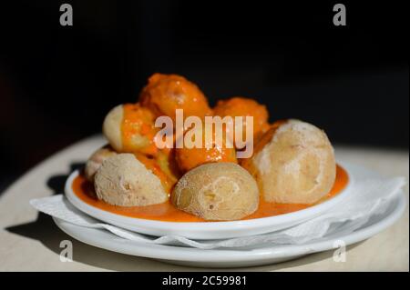 Canarian Salt Wrinkled Potatoes Papas Arrugadas with spicy red pepper sauce mojo rojo Stock Photo