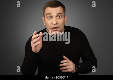 surprised man with wide opened eyes. Studio shot Stock Photo
