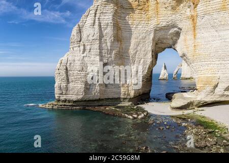 The Needle seen through the arch of the Manneporte cliff at the ...