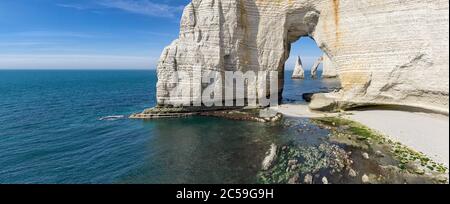 The Needle seen through the arch of the Manneporte cliff in Etretat ...