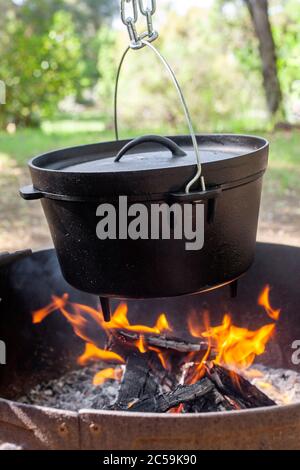 https://l450v.alamy.com/450v/2c59k90/close-up-of-cast-iron-dutch-oven-hanging-over-open-fire-2c59k90.jpg