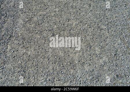 Dusty gravel road surface texture with small pebbles Stock Photo