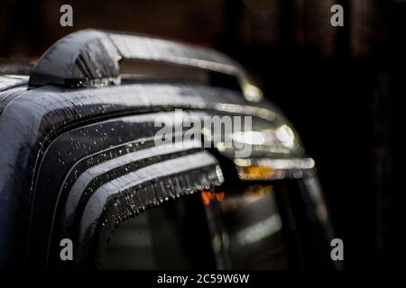 Abstract photograph of water dripping from the side of a car Stock Photo