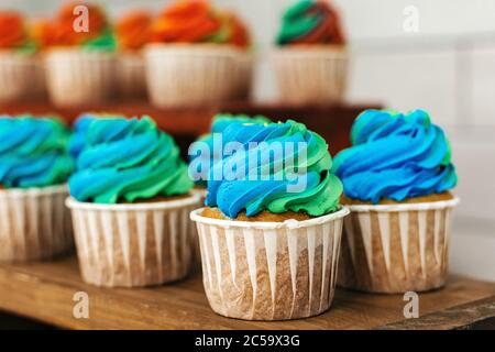Colored cakes in baskets on a wooden table Stock Photo