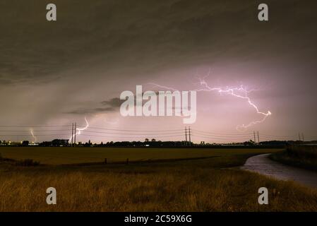 Lightning storm over a wheat field at night Stock Photo