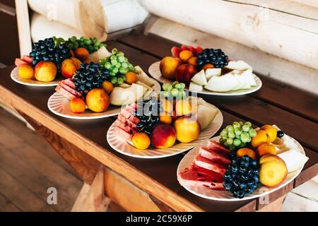 Plates with fruits on a wooden table Stock Photo