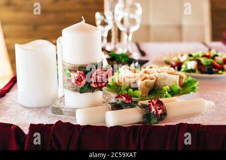 Arrangement of candles and dishes on a wedding table Stock Photo