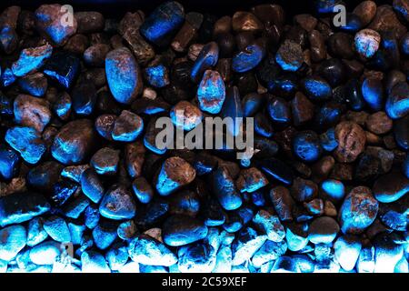 Small decorative stones with blue backlight in dark colors Stock Photo