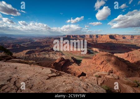 Clouds billow as the Colorado River flows around the bend of Dead Horse Point in Utah Stock Photo