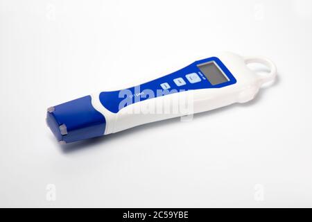 A digital pH measuring device on a white background. Modern laboratory equipment. Stock Photo