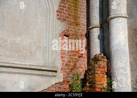 A fragment of a brick wall with paint peeling off. Stock Photo