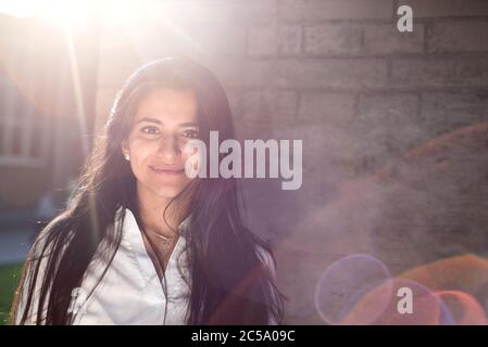 Portrait of a beautiful young girl, Indian nationality. On the background of the wall texture. Outdoors Stock Photo