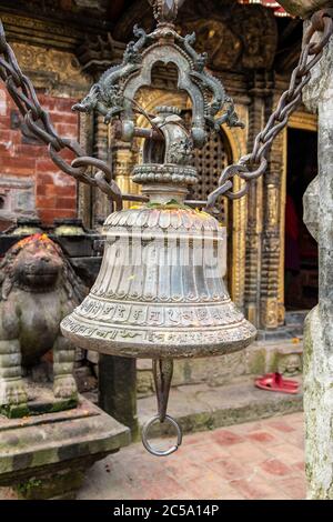 Votive bells placed in front of the entrance of a Buddist Temple, Kathmandu Valley, Nepal Stock Photo