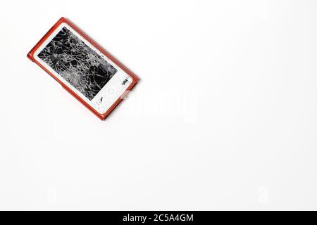 An MP3 player with a broken glass screen. Damaged glass. Stock Photo