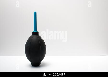 An air blower for cleaning the sensor and lens of a digital DSLR camera. Sensor cleaning and lens cleaning. Dust removal. Stock Photo