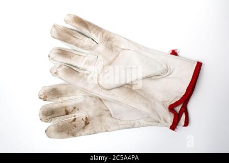 A pair of used leather work gloves on a white background. Personal safety equipment. Stock Photo