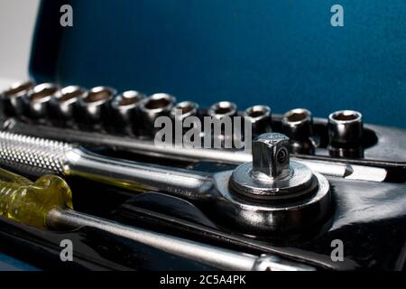 Closeup of a small socket set in a metal storage box with the sockets on the background. Socket wrench set. Stock Photo