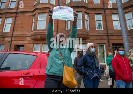 Glasgow, Scotland, UK. 1st July, 2020. Pictured: Anti-Racism campaigners, Stand Up To Racism, protest outside the entrance of Glasgow's Home Office to highlight 'dreadful conditions' and hardship suffered by refugees and asylum seekers during the coronavirus (COVID19) lockdown in Glasgow. Credit: Colin Fisher/Alamy Live News Stock Photo
