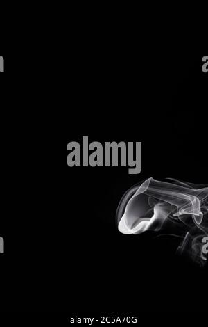 Abstract white smoke or steam swirls on black background Stock Photo