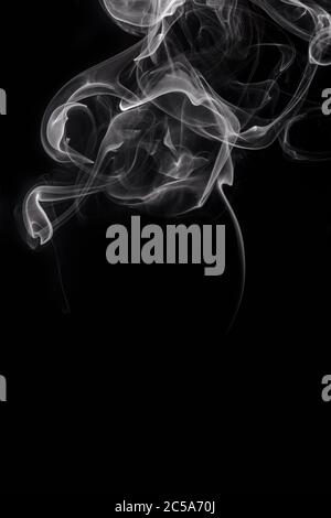 Abstract white smoke or steam swirls on black background Stock Photo