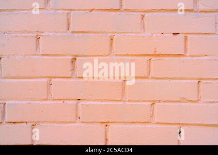 Brick wall texture. Brick wall painted with pink paint. Stock Photo