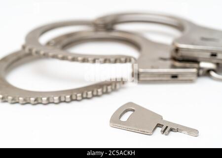 Metal handcuffs. Detention of criminals breaking  law. Restriction of freedom. Stock Photo