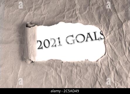 Word 2021 Goals on torn brown grunge paper background. new year 2021 resolution, setting up goals, targets to achieve concept. Stock Photo