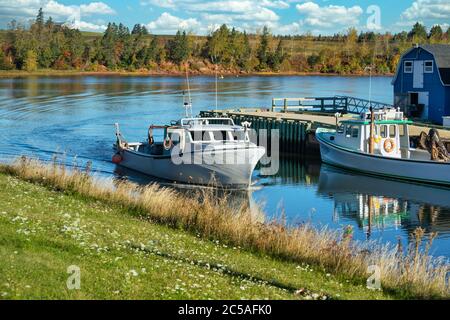 Lobster fishing boat sailing into port in rural Prince Edward Island, Canada. Stock Photo