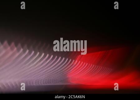 Beautiful shot of intersecting refracted red light layers on a black background Stock Photo