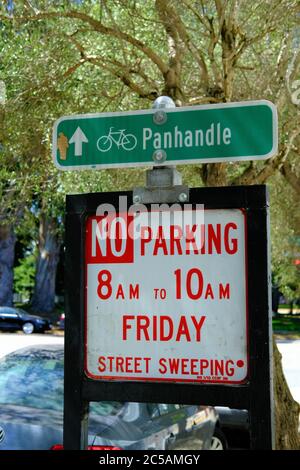 Sign for bicycle riders pointing to Panhandle Park in San Francisco, California, USA; No Parking warning for street sweeping on Friday from 8 to 10 am. Stock Photo