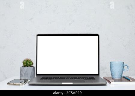 Laptop with blank empty screen on white table in interior. mockup Stock Photo